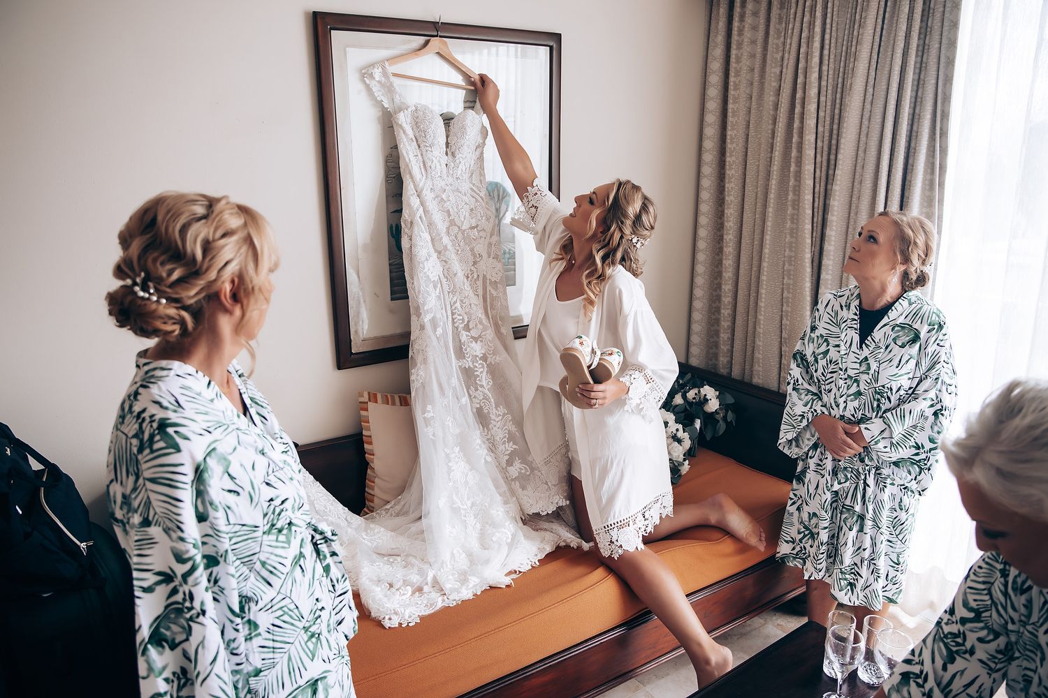 A sequence of photos showing someone in a floral robe helping another person get dressed in a white gown.