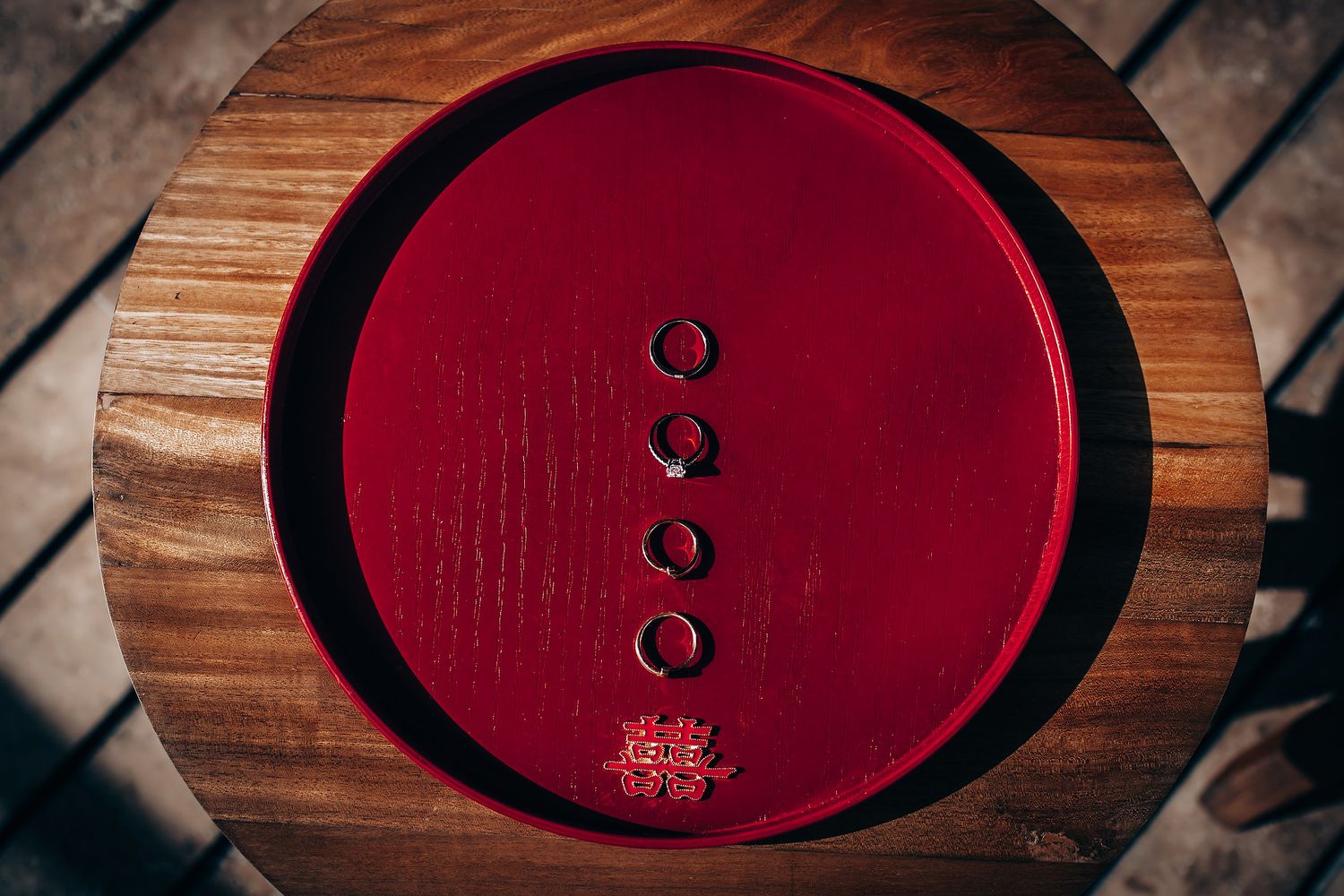 Red circular tea serving trays arranged on wooden surface during traditional ceremony.