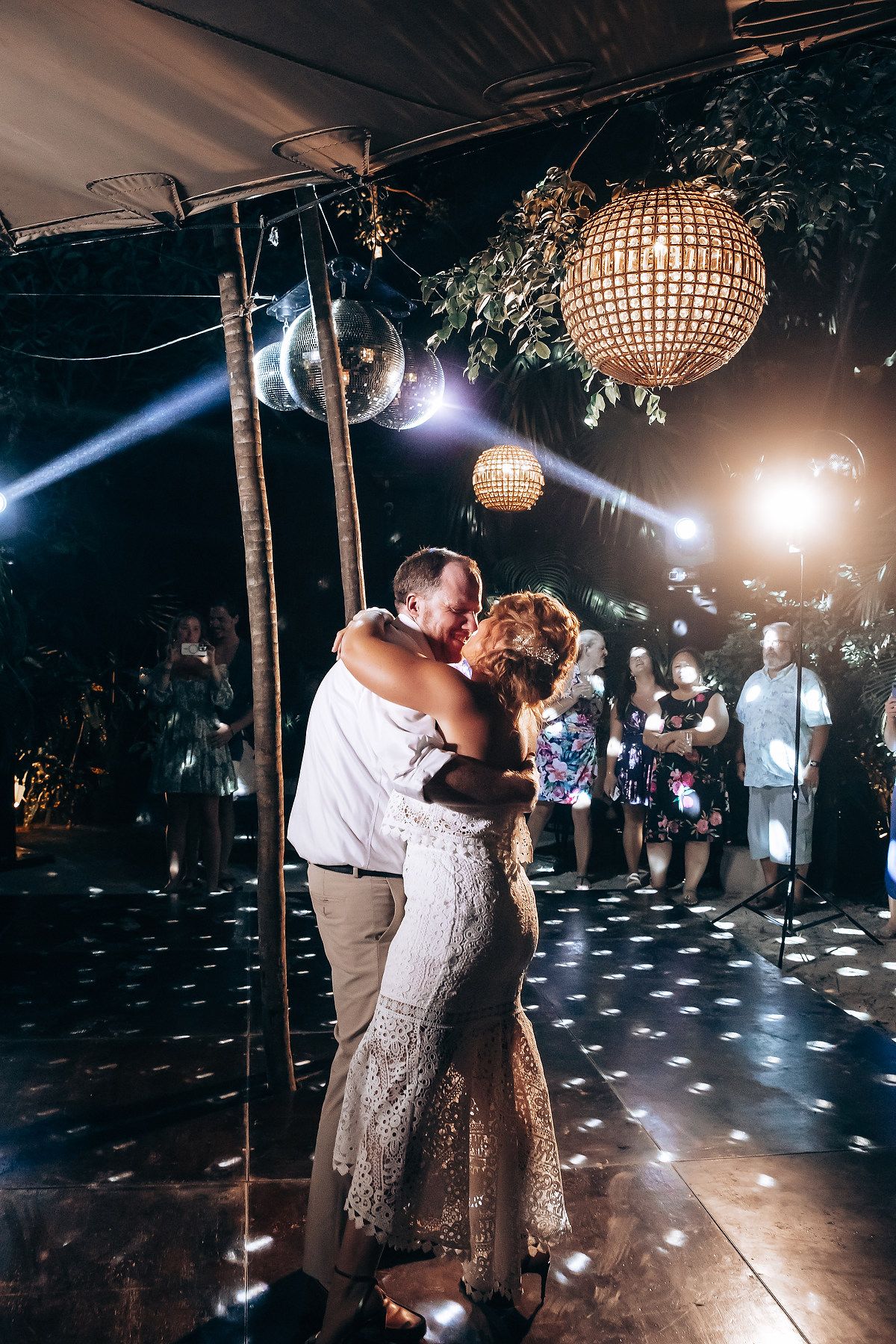 Romantic dance scene with disco ball lighting and atmospheric effects.