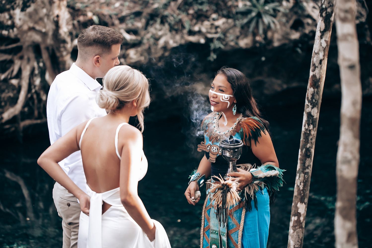 Traditional ceremony taking place in atmospheric cave setting with decorative elements.
