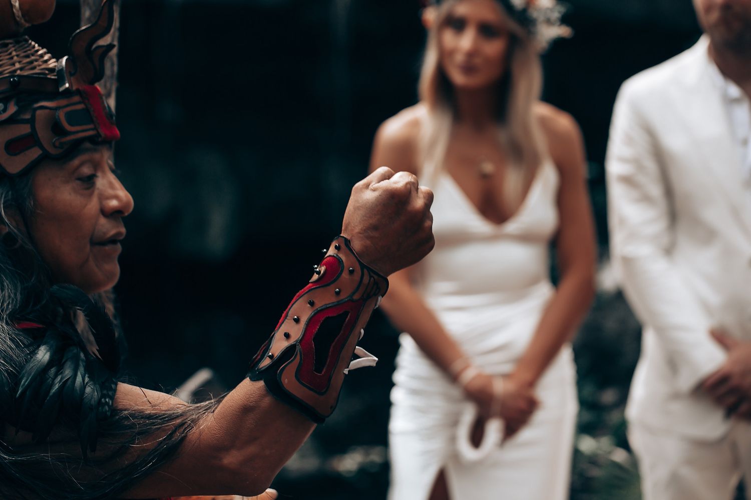 Traditional spiritual ceremony leader performing rituals during an outdoor wedding ceremony.