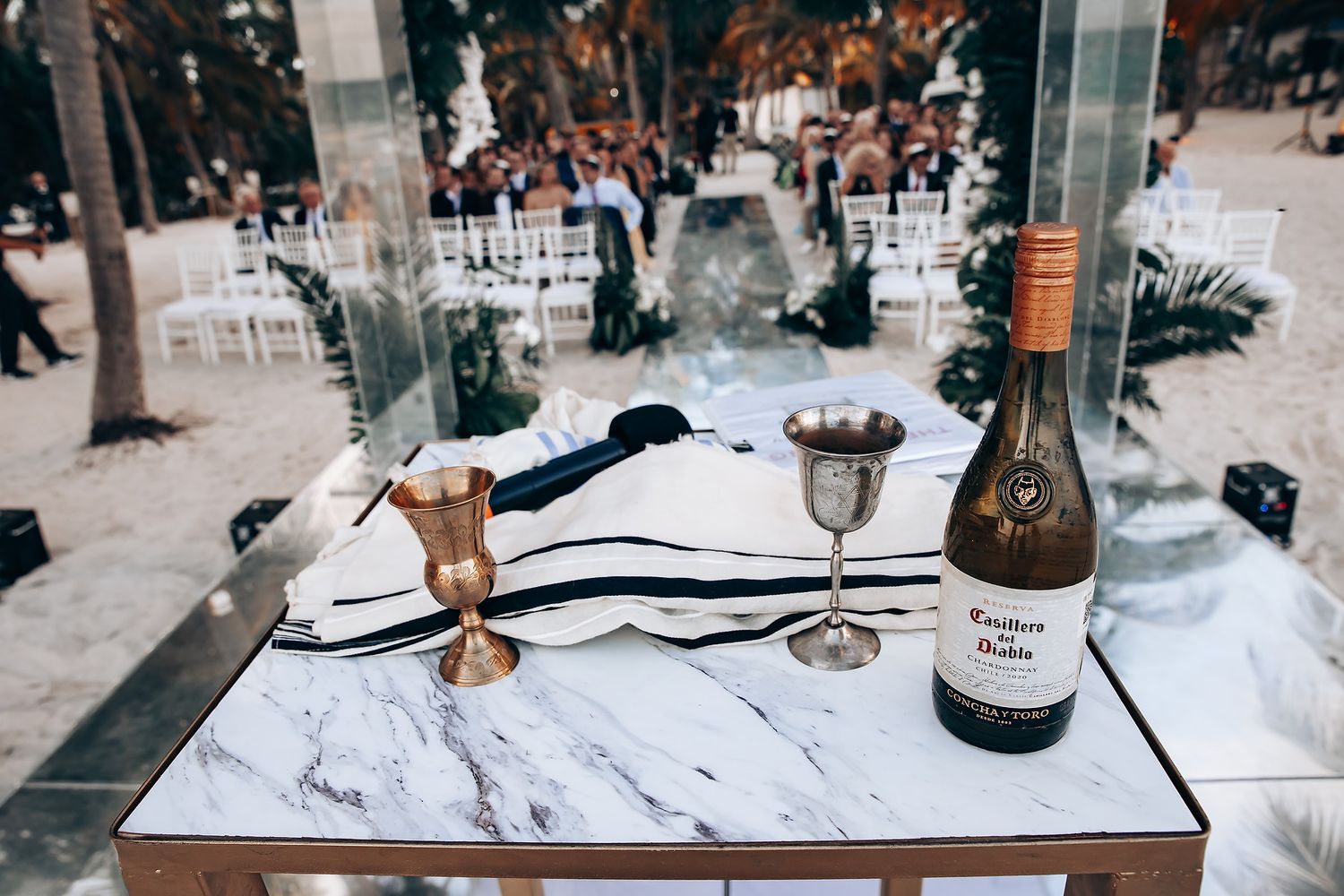 Elegant table settings with marble surfaces and decorative elements at a formal event.