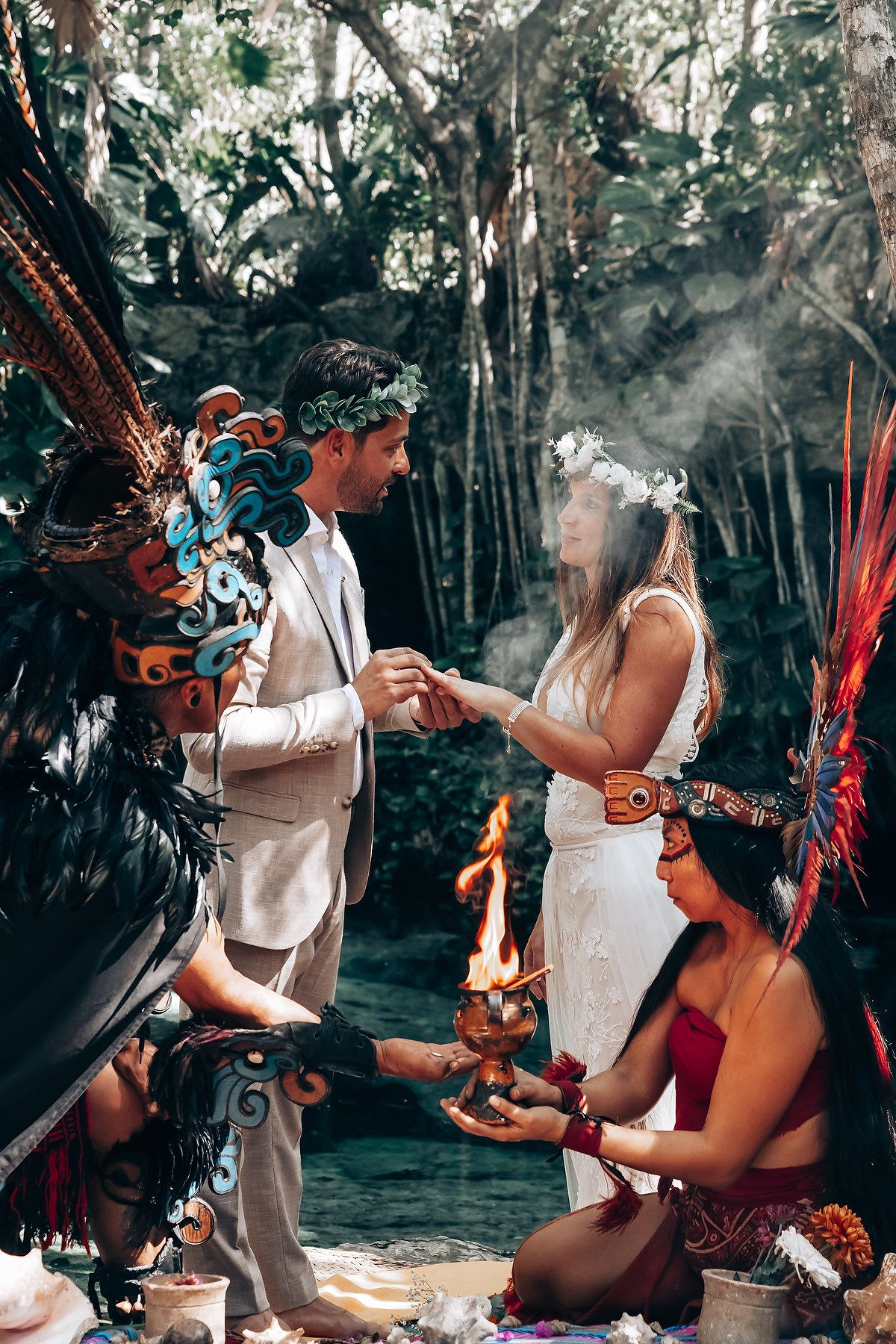 Sacred Mayan wedding ritual with fire elements and traditional ceremonial dress in forest setting.