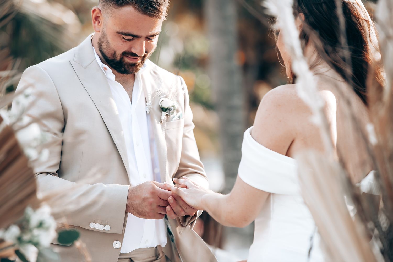 A couple shares a romantic moment together during their wedding celebration outdoors.