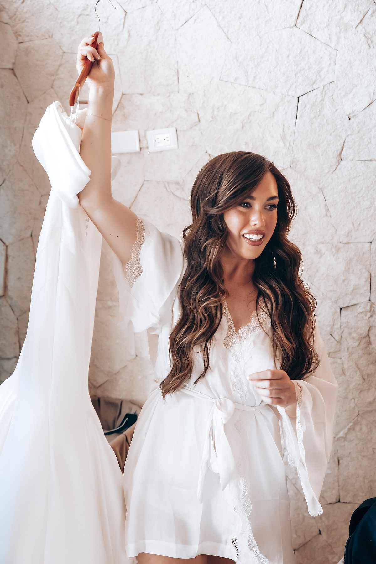 A woman in a white button-down shirt poses against a white textured wall in a series of candid lifestyle shots.