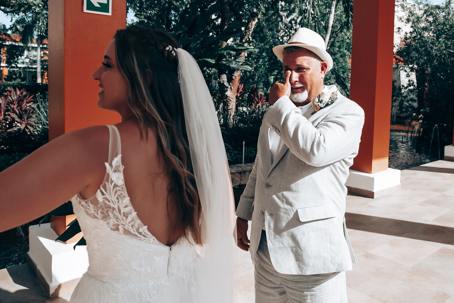 Romantic wedding moments captured against a rustic orange wall backdrop.