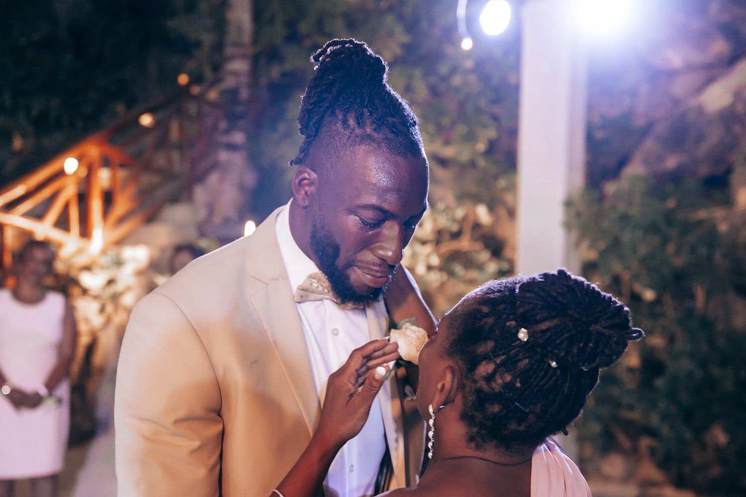 Evening wedding reception celebration with dramatic lighting and decor.