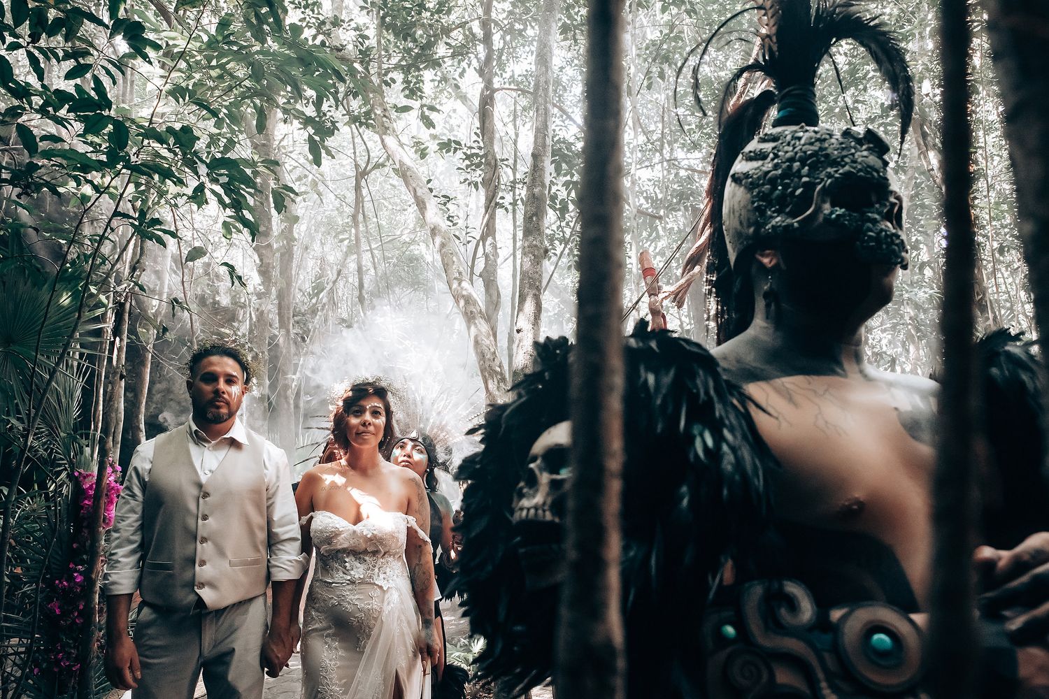 An intimate forest wedding ceremony unfolds with misty trees creating a magical atmosphere.