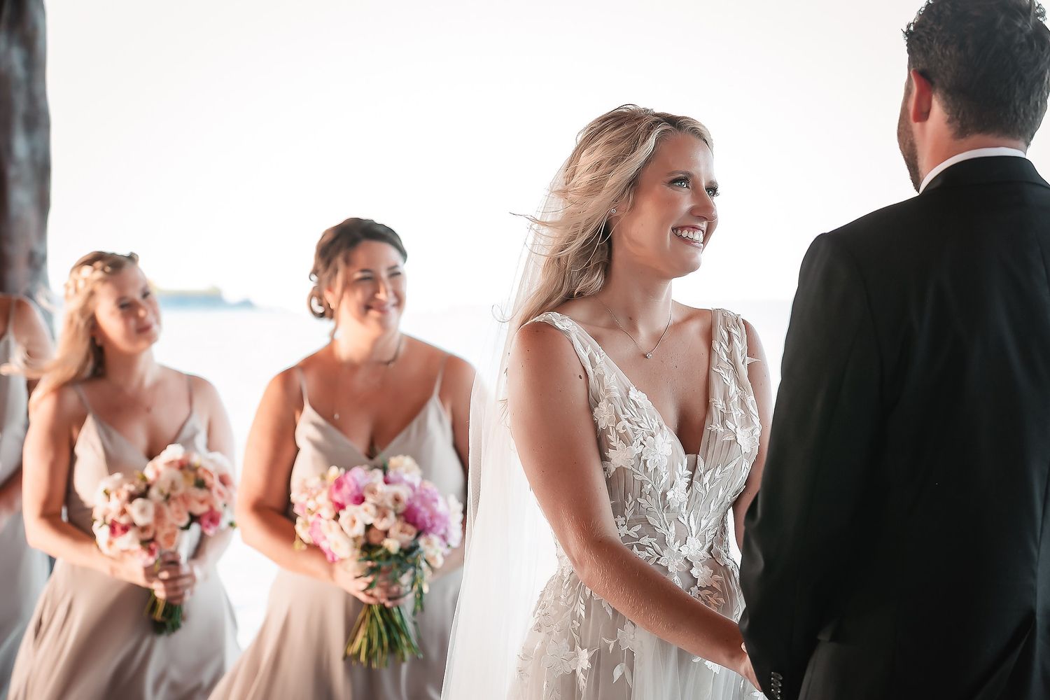 Candid wedding ceremony moments captured in bright outdoor setting.