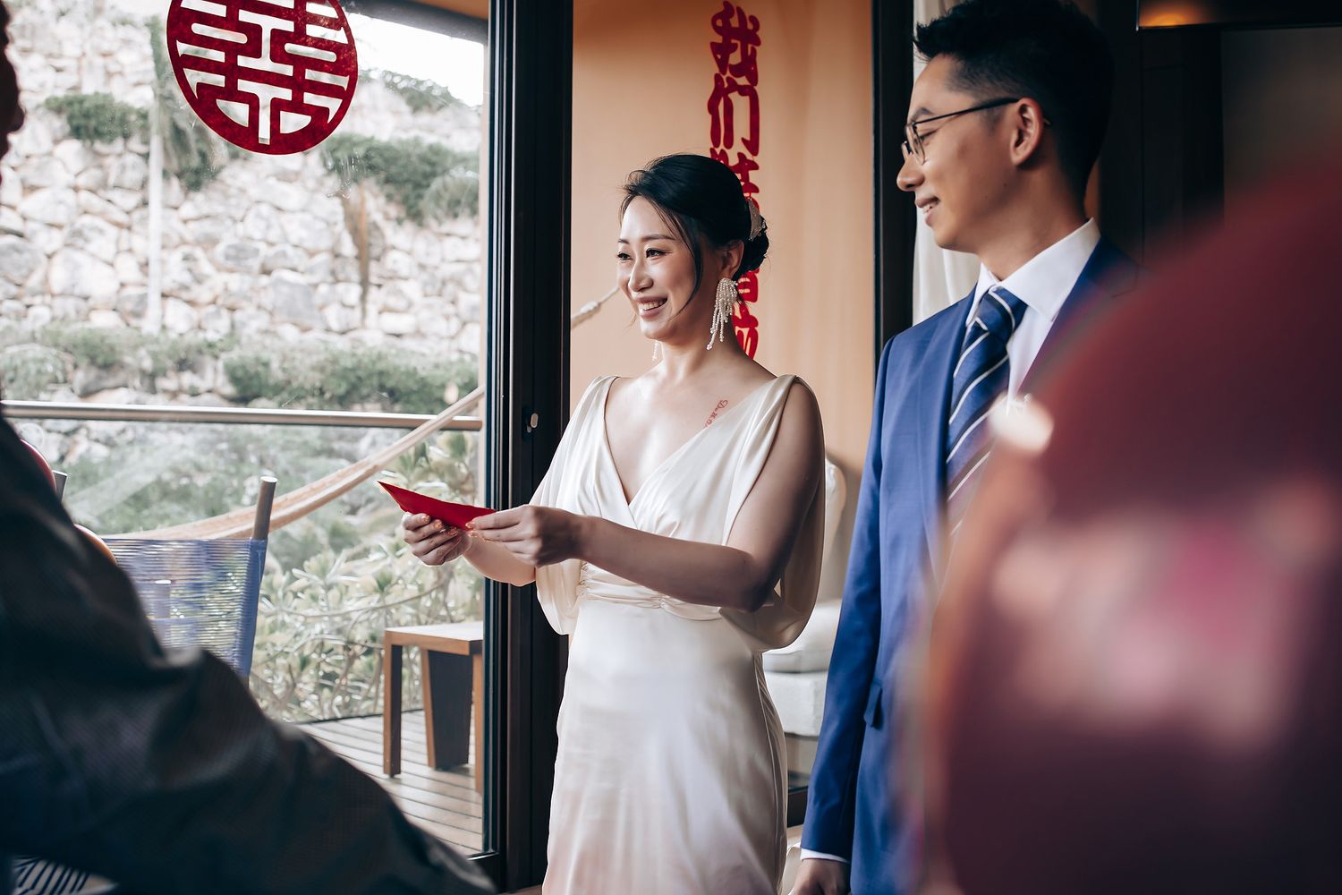 Traditional Chinese wedding ceremony with double happiness symbol and red decorations.