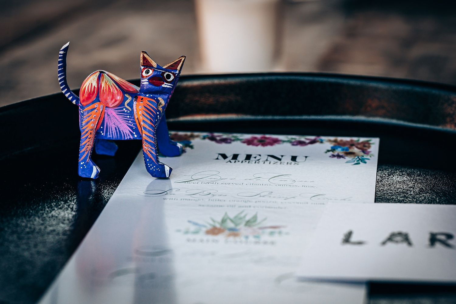 Colorful origami butterflies delicately placed on handwritten paper create an artistic composition.