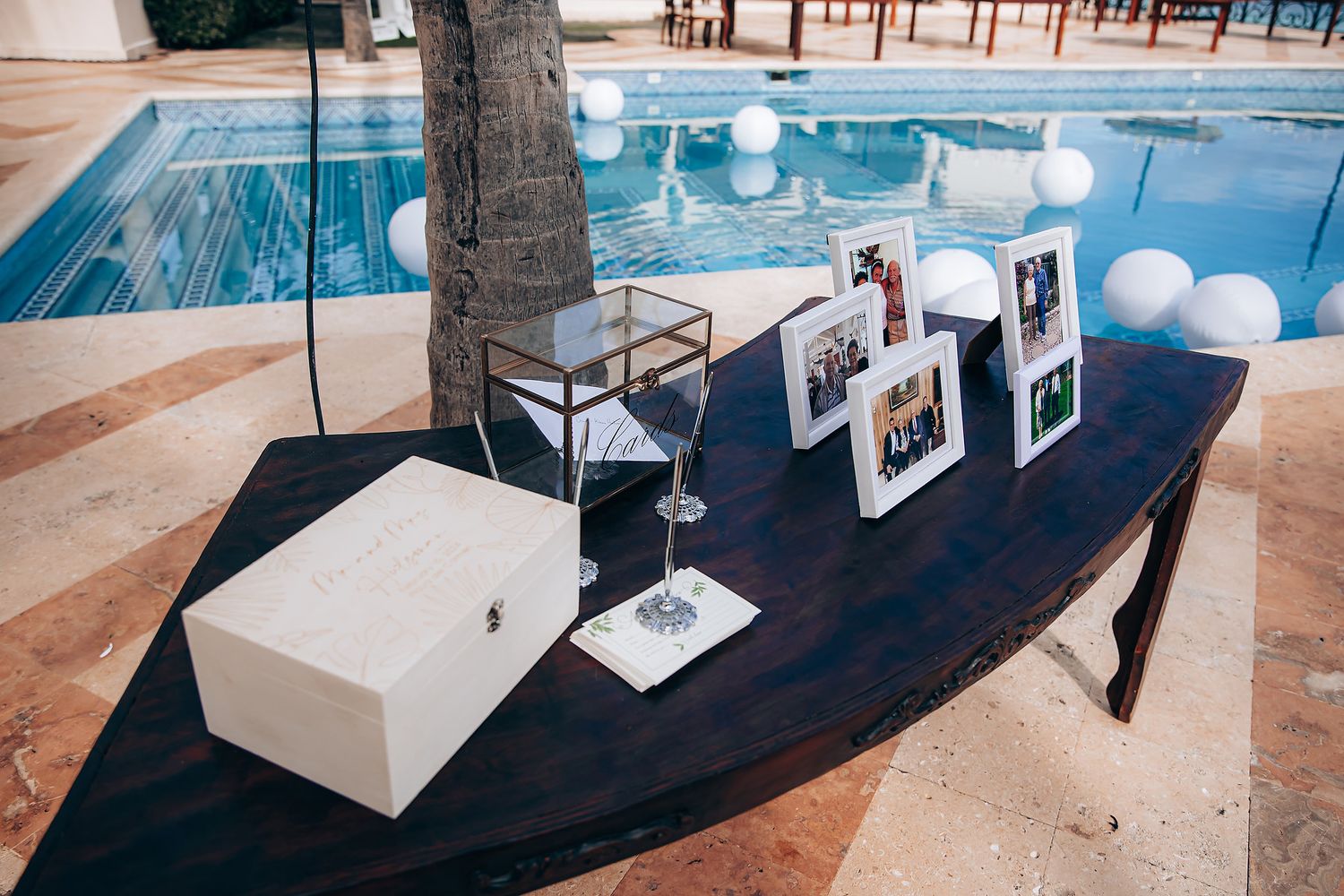 Art gallery exhibition space with white angular display pedestals and framed photographs arranged in a modern setting.