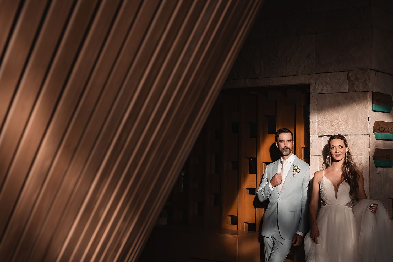 Modern architectural wedding venue with dramatic lighting and angular design elements.