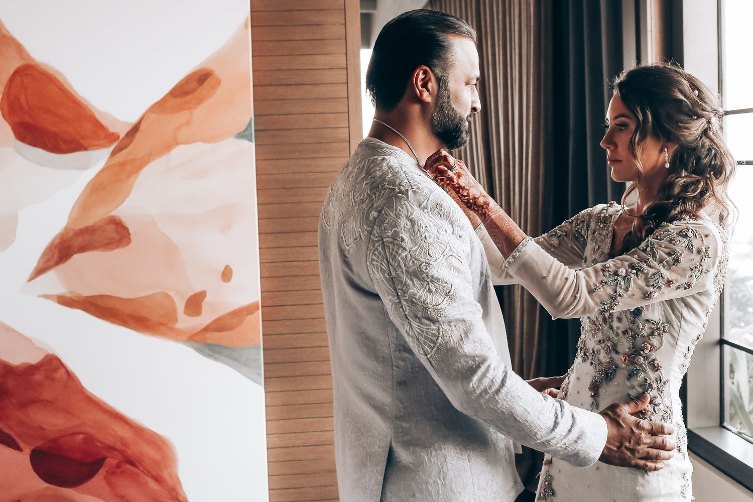 A couple in white attire sharing intimate moments by a window in a romantic wedding photo collage.