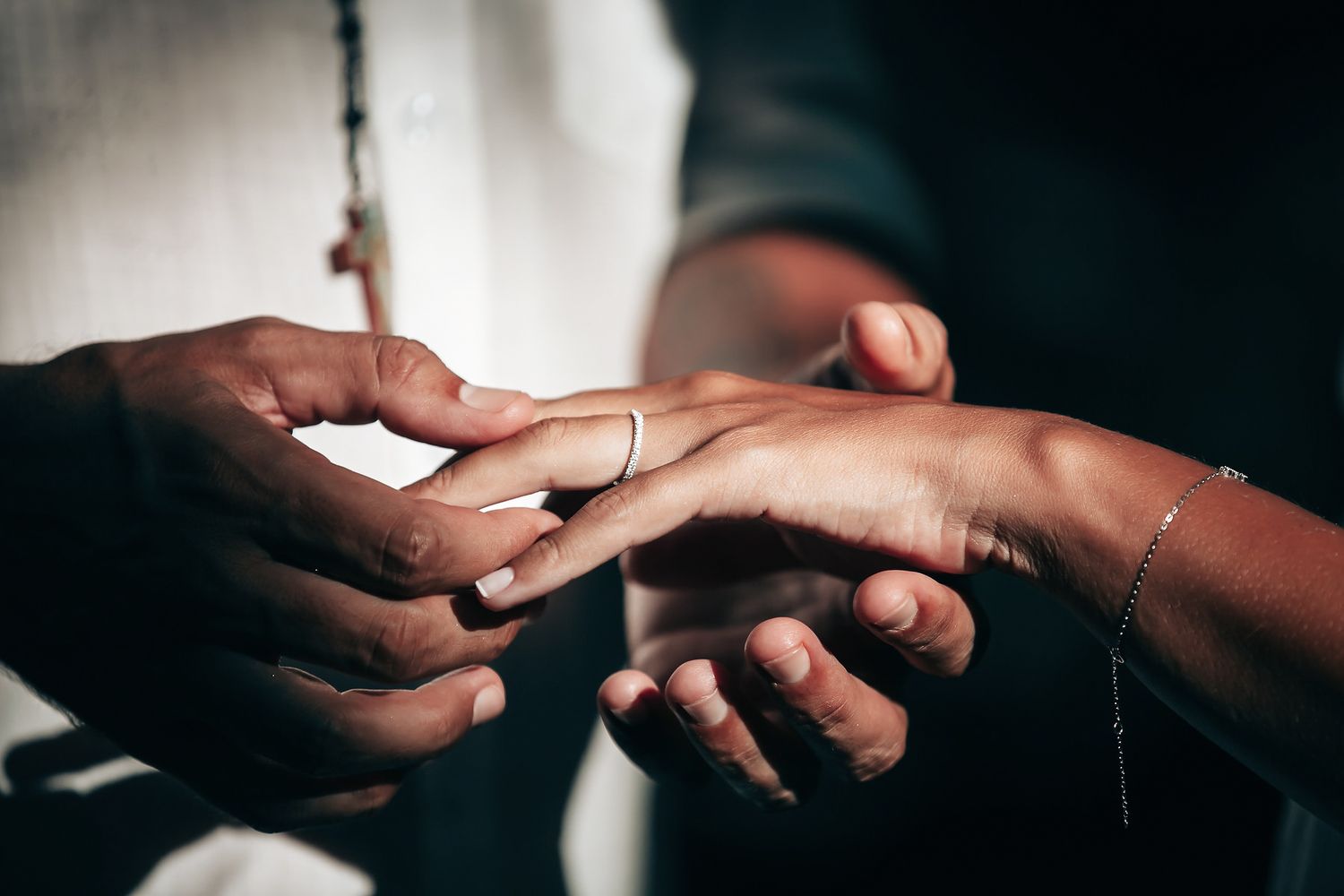 Two people's hands are joined together in a gesture of affection.