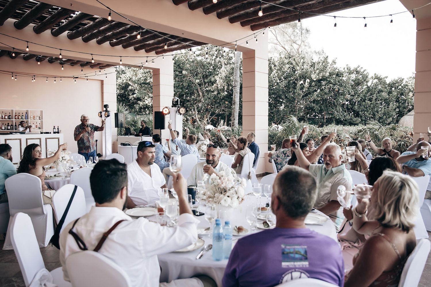 A wedding reception with guests seated at tables and enjoying the celebration.