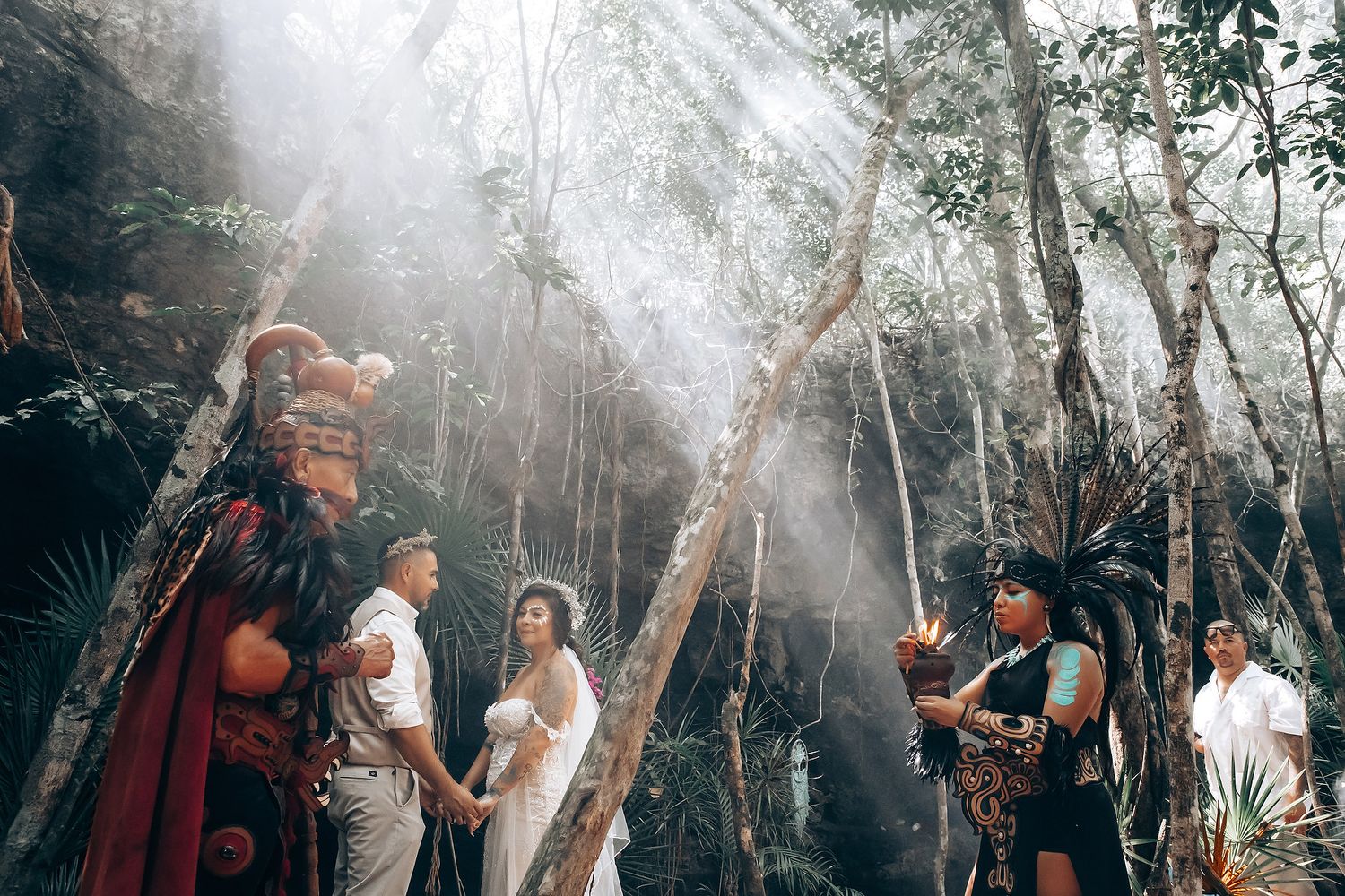Atmospheric wedding ceremony in a misty forest setting with natural light filtering through trees.