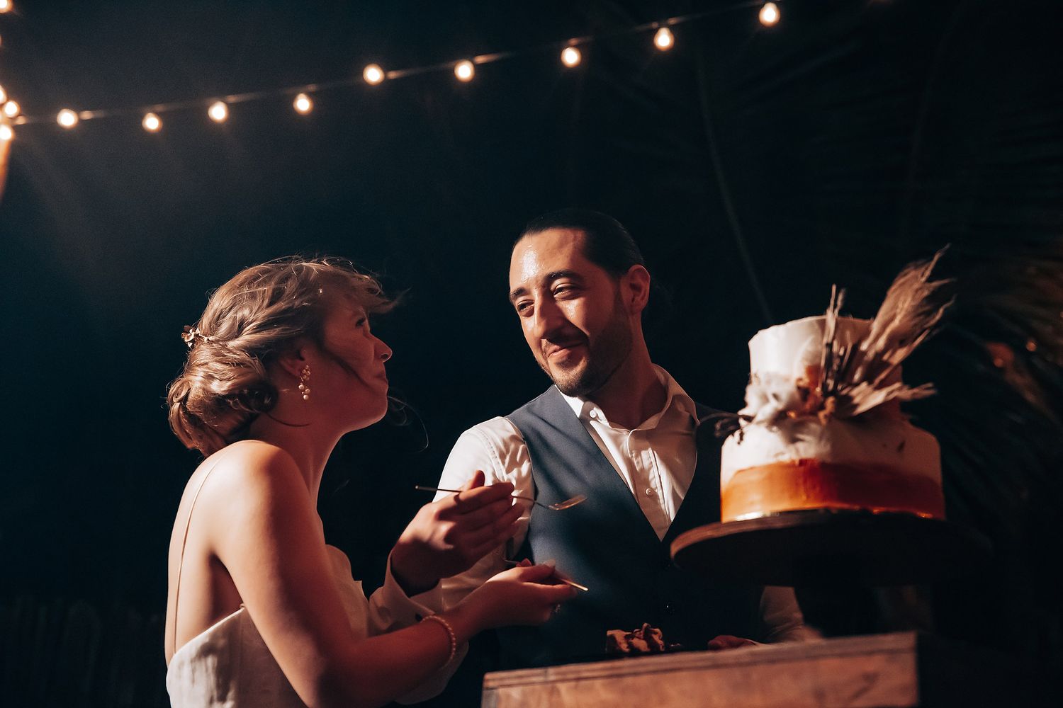 Evening wedding reception with string lights creating a romantic ambiance.