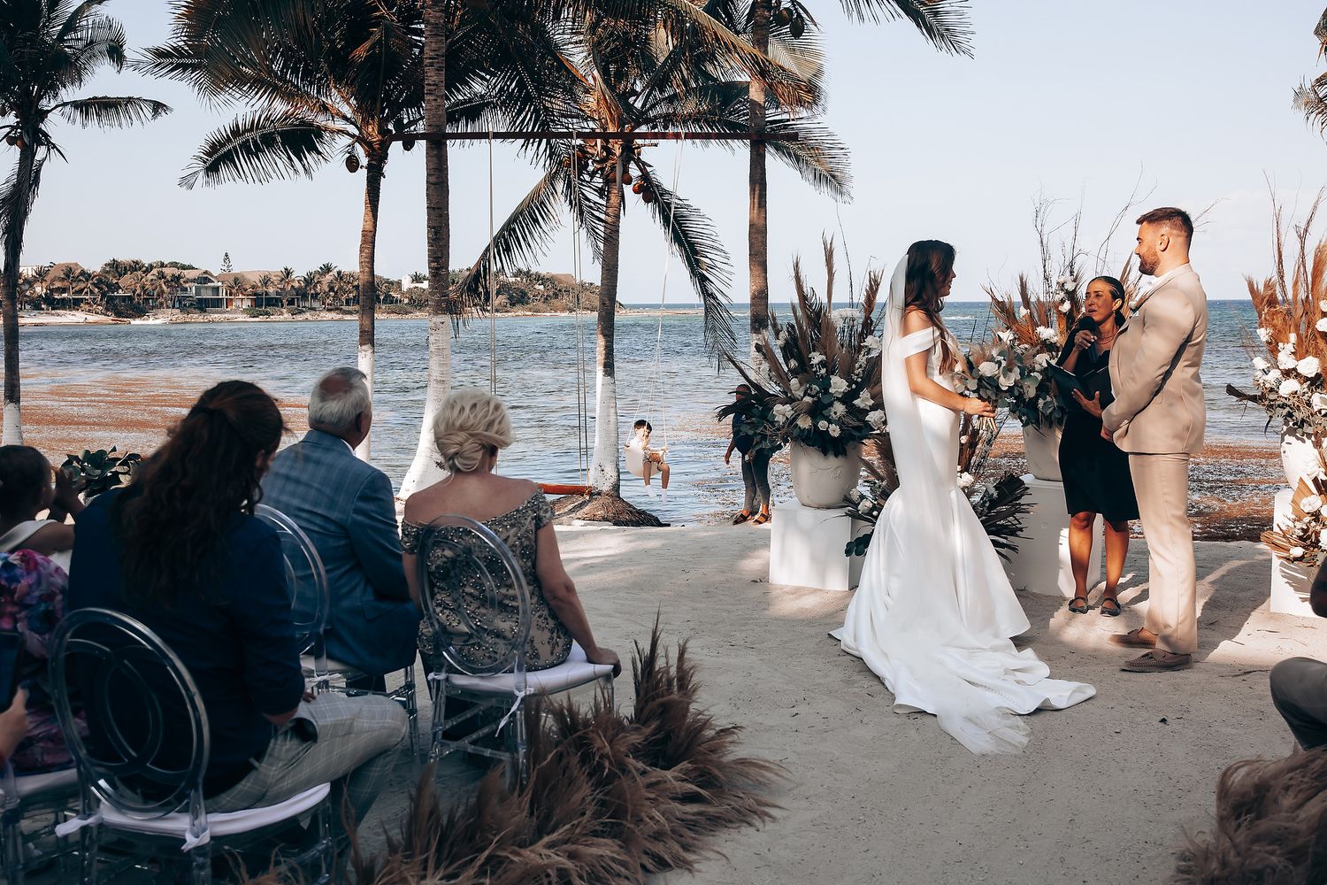 A series of beach wedding ceremony photos showing palm trees, ocean views and guests gathered on the sand.