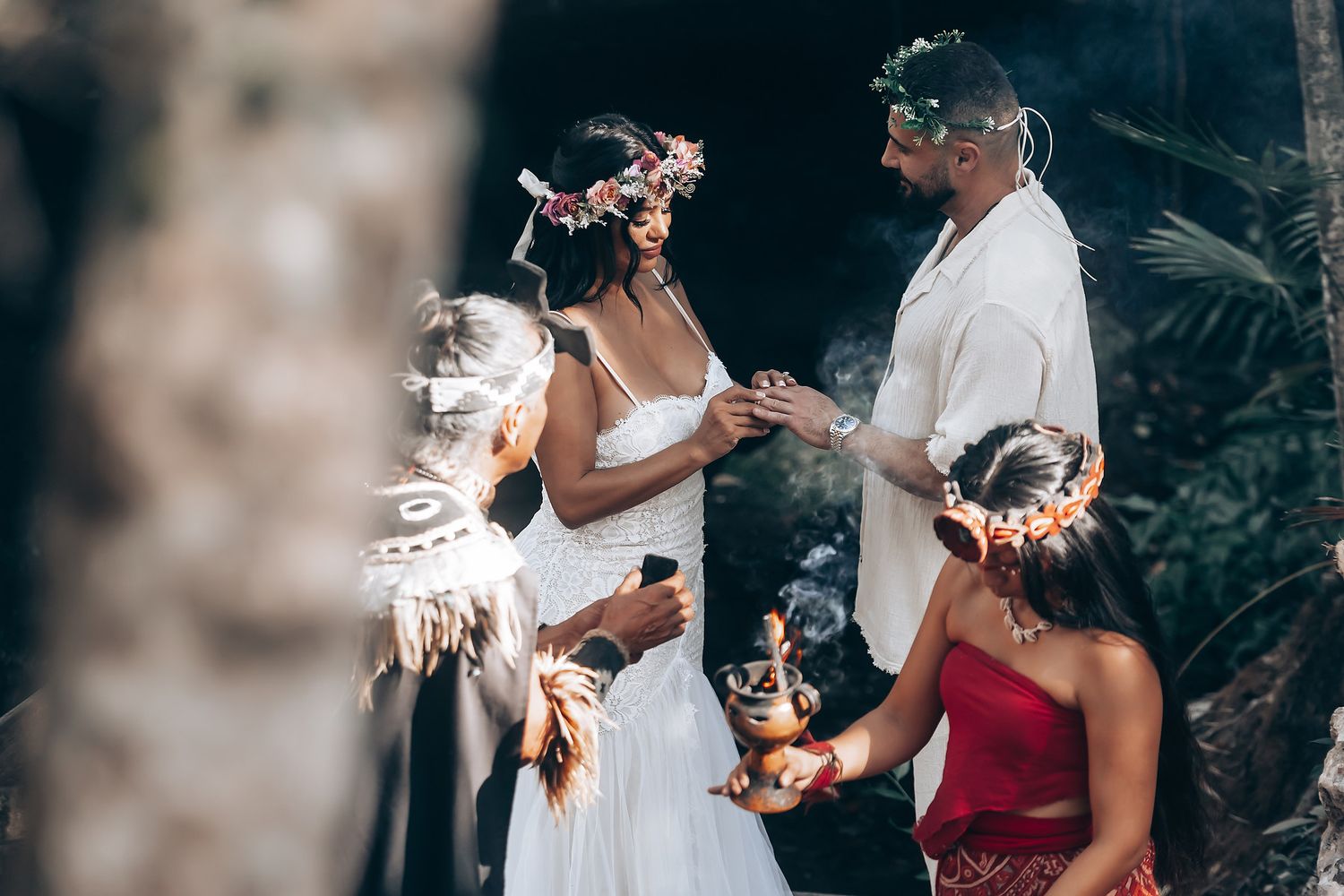 Wedding party members share a celebratory toast with champagne glasses during an outdoor celebration.