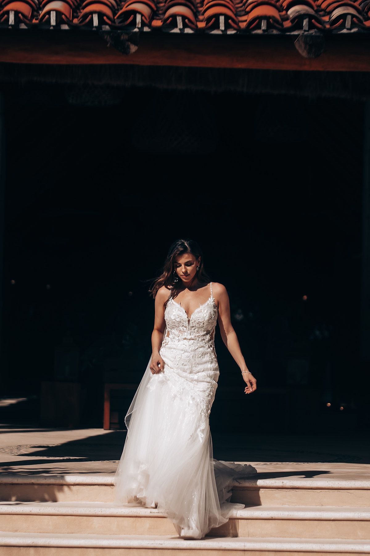 A sequence of photos showing a person in a white wedding dress walking and dancing on a sunlit floor.