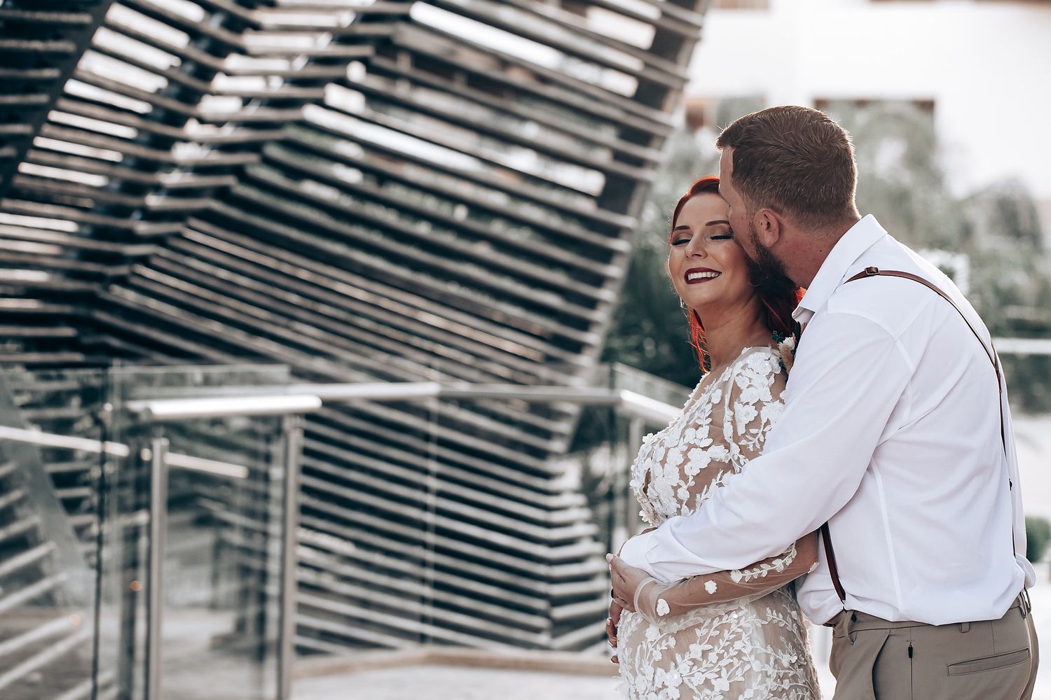 Newlyweds share tender moments in an industrial-style venue.