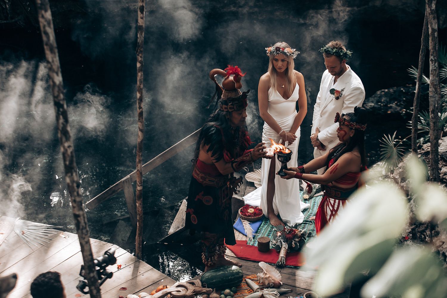 Guests enjoy festivities at a forest wedding celebration with natural scenery.