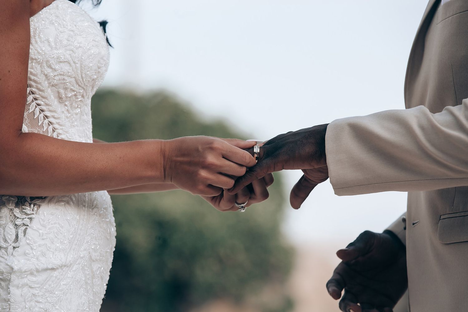 A couple exchanges rings during an intimate wedding ceremony moment.