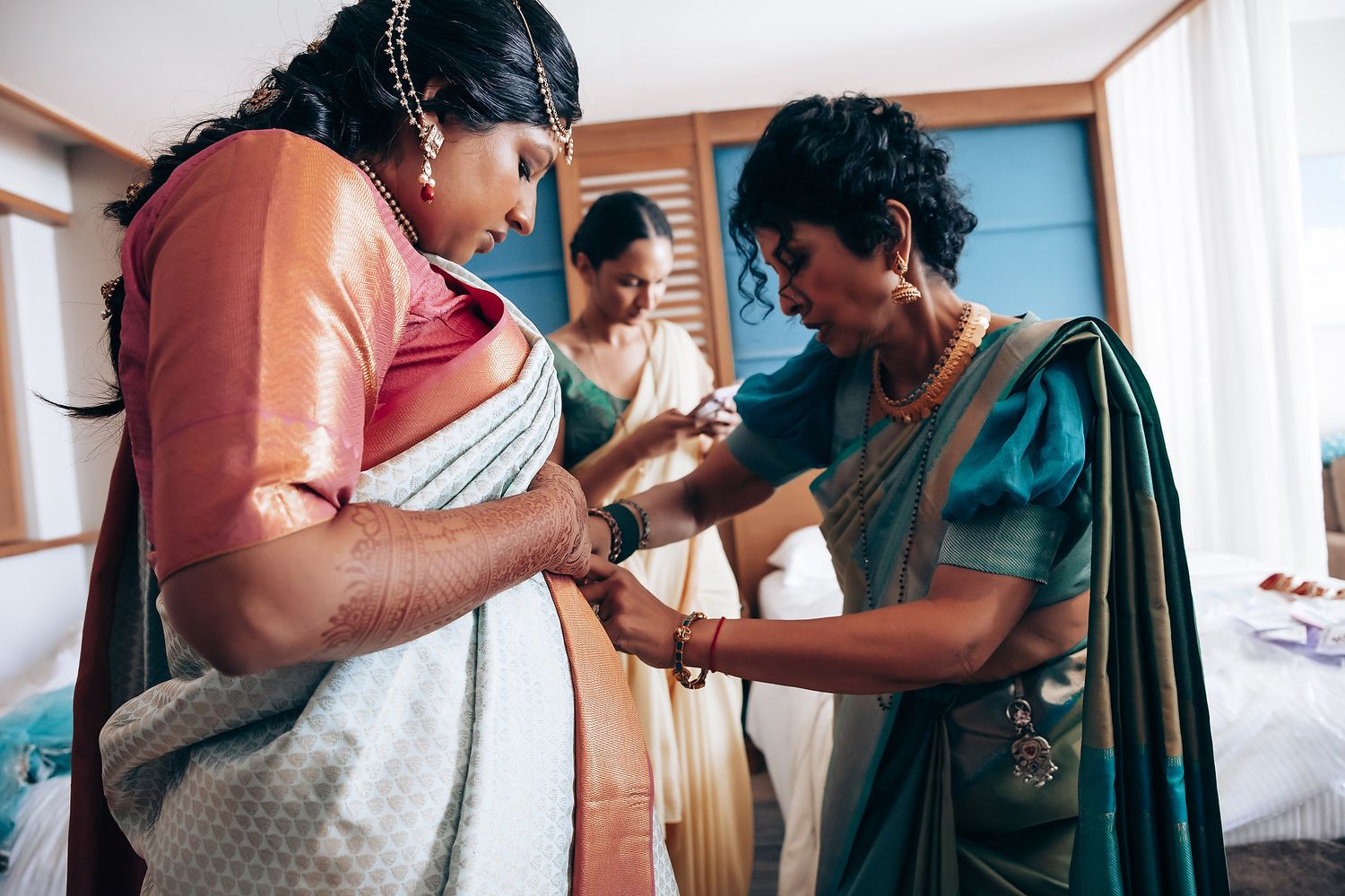 A series of connected photos showing a traditional Indian wedding preparation with people getting ready in colorful attire.