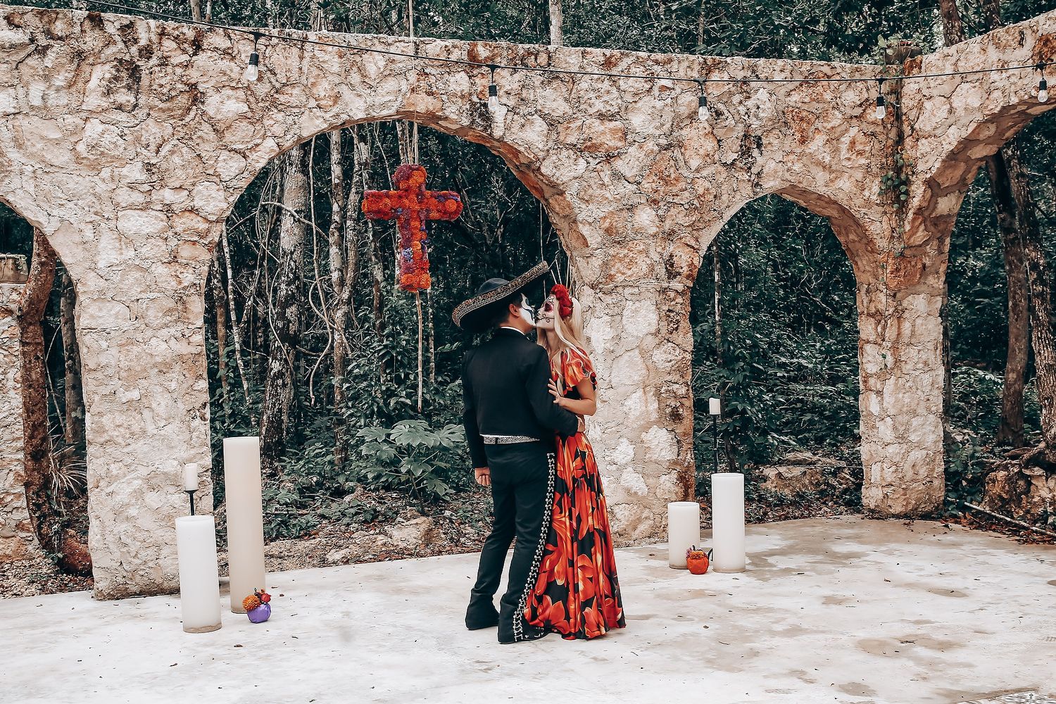 Stone archway corridor creates dramatic backdrop for gothic-themed wedding photography session.