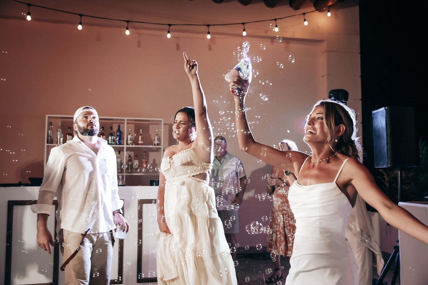 A group of people dancing at what appears to be an outdoor wedding or event.