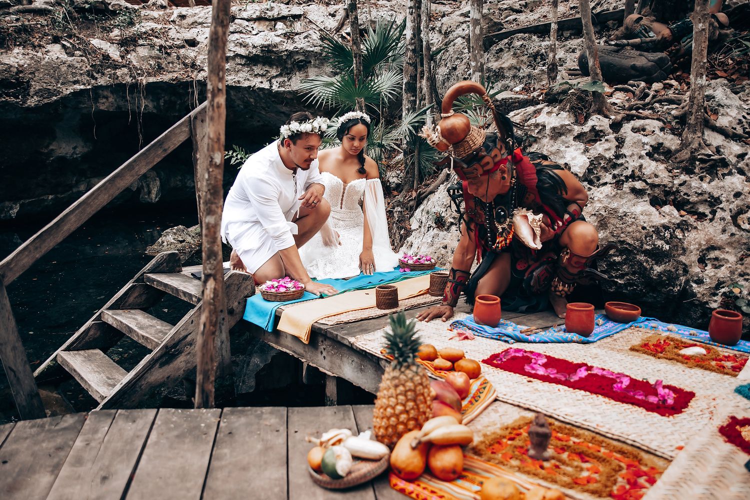 People enjoying a traditional Japanese tea ceremony with matcha and sweets on wooden platform outdoors.