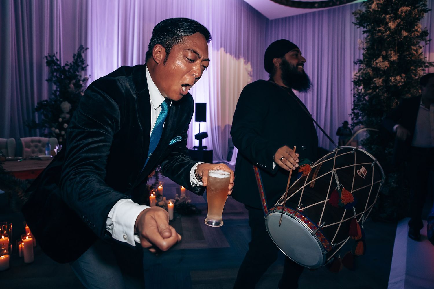Musicians performing at an elegant indoor wedding reception with ambient lighting.