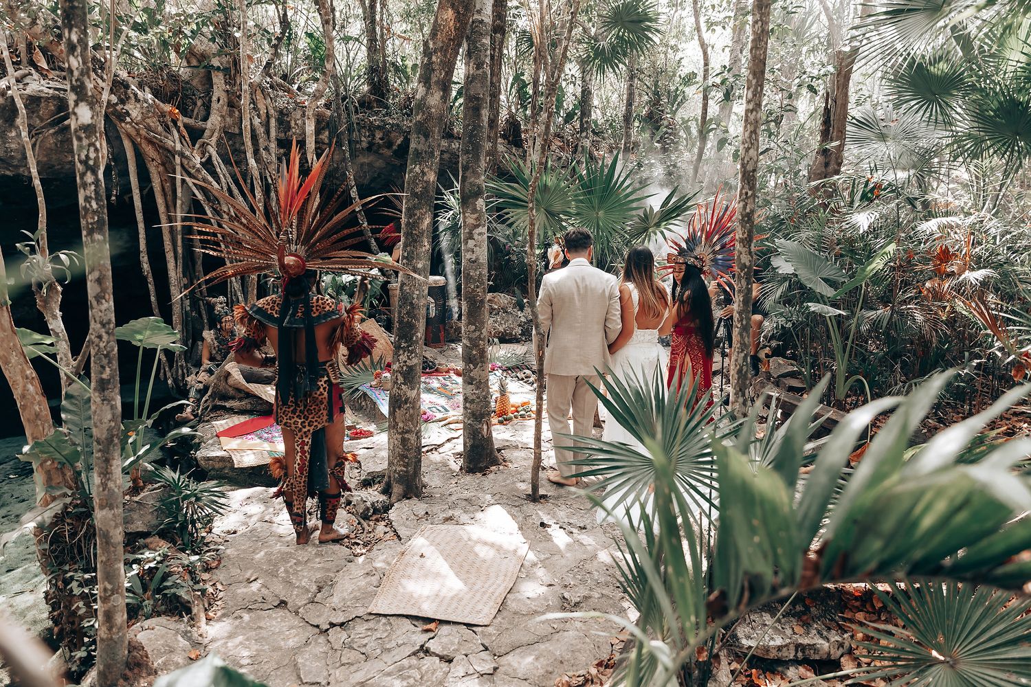 A scenic pathway through a tropical forest with palm trees and natural vegetation creates a serene atmosphere.