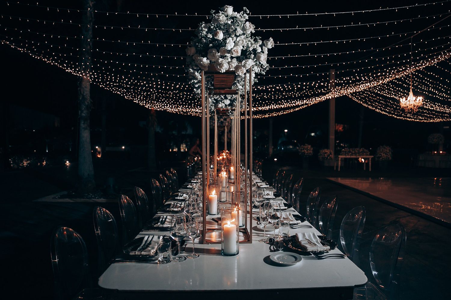 Enchanting nighttime wedding reception with twinkling string lights creating a magical atmosphere.