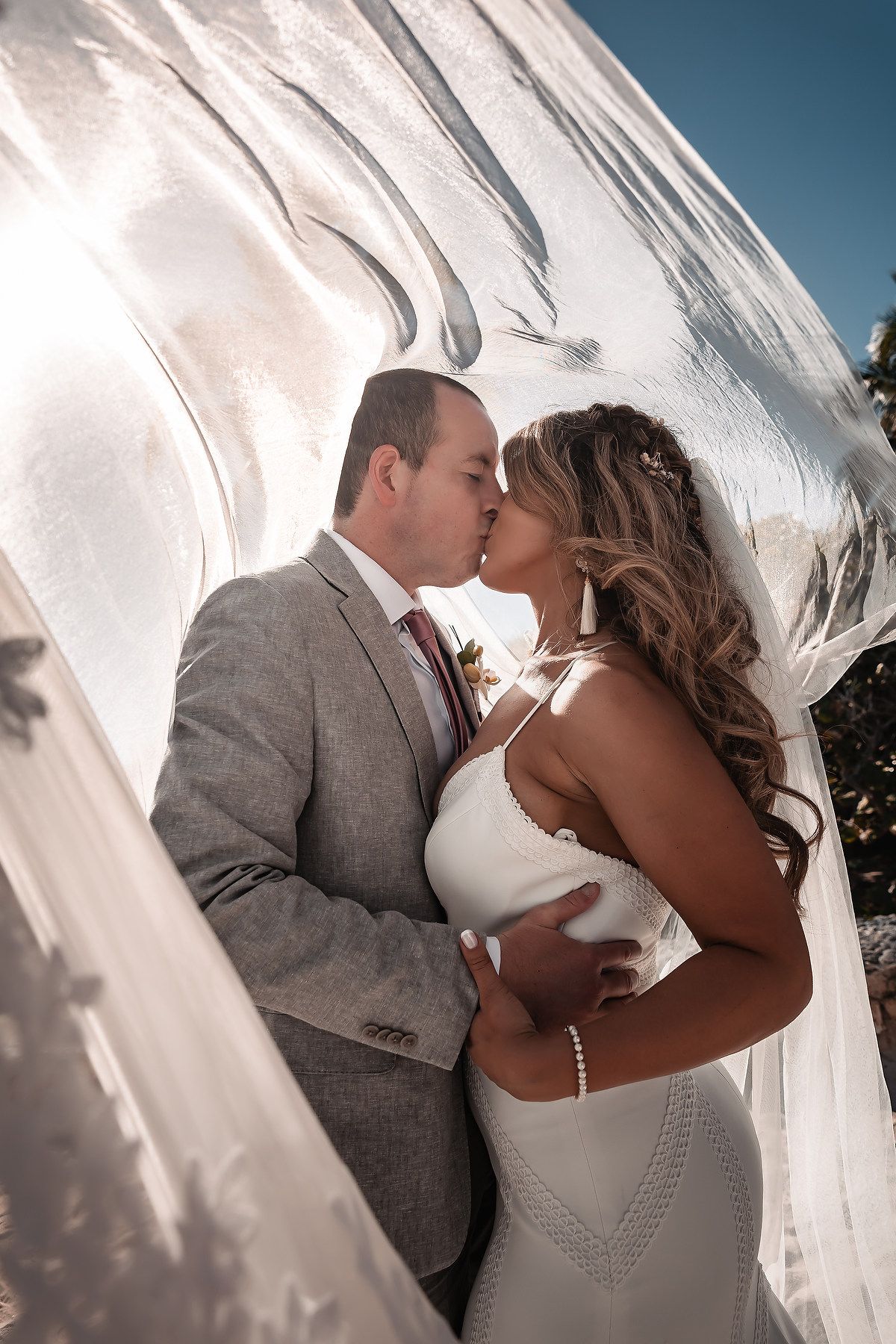 Bride and groom kiss during ceremony at Bahia Principe Tulum