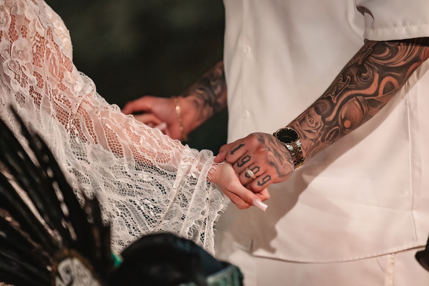 Close-up details of white lace wedding attire with intricate patterns.