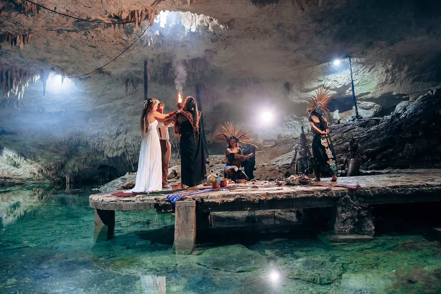 A scenic cave wedding ceremony space with ethereal lighting and natural rock formations.