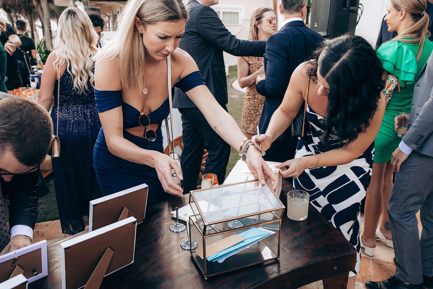 A group of people gather around a table working together on a hands-on activity with supplies and materials.