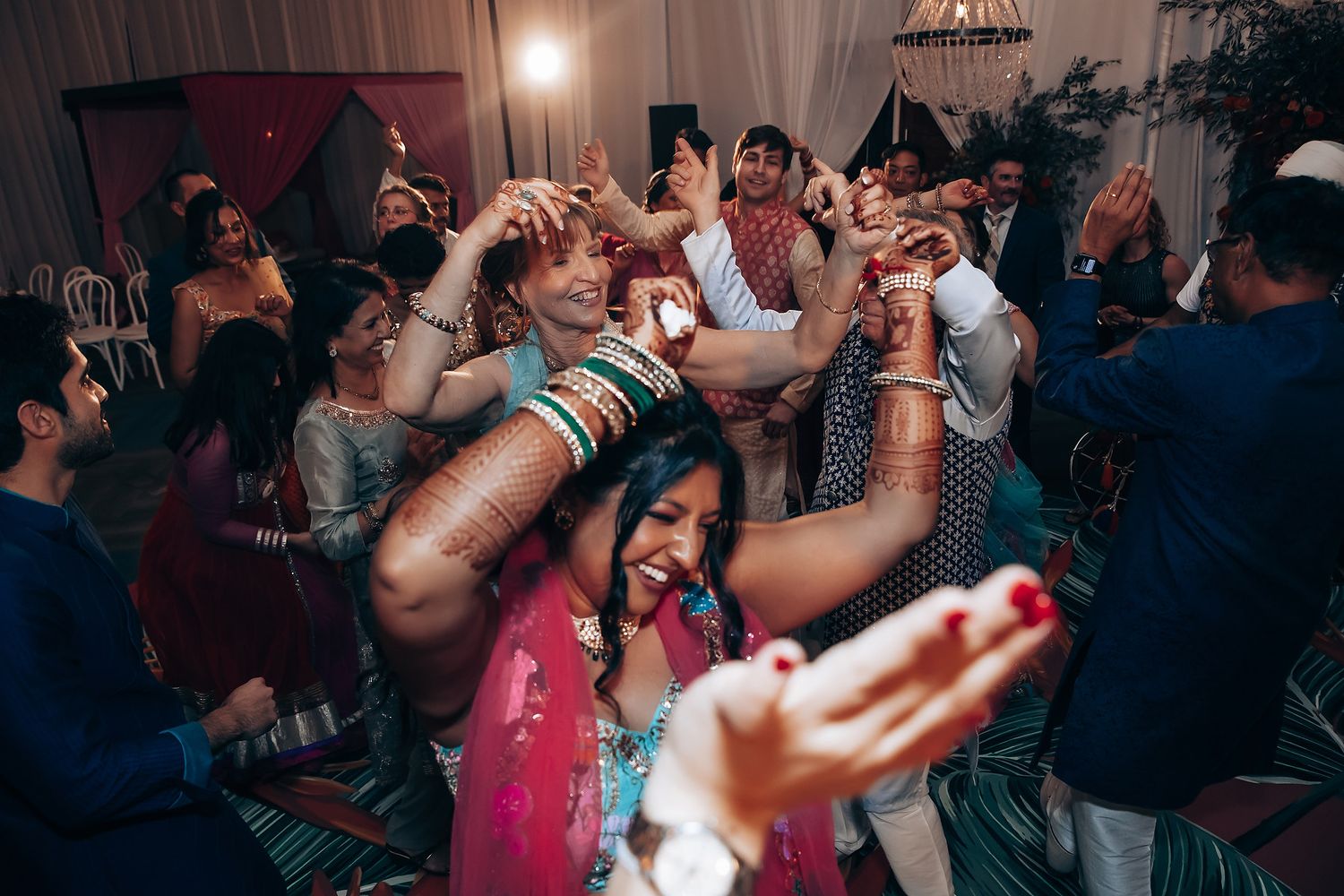 Lively party scene with dancing and celebration under dim lighting.