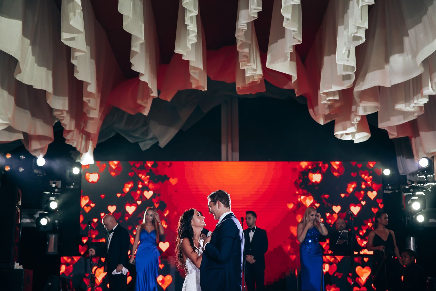 Wedding reception venue with dramatic paper lantern ceiling installation.