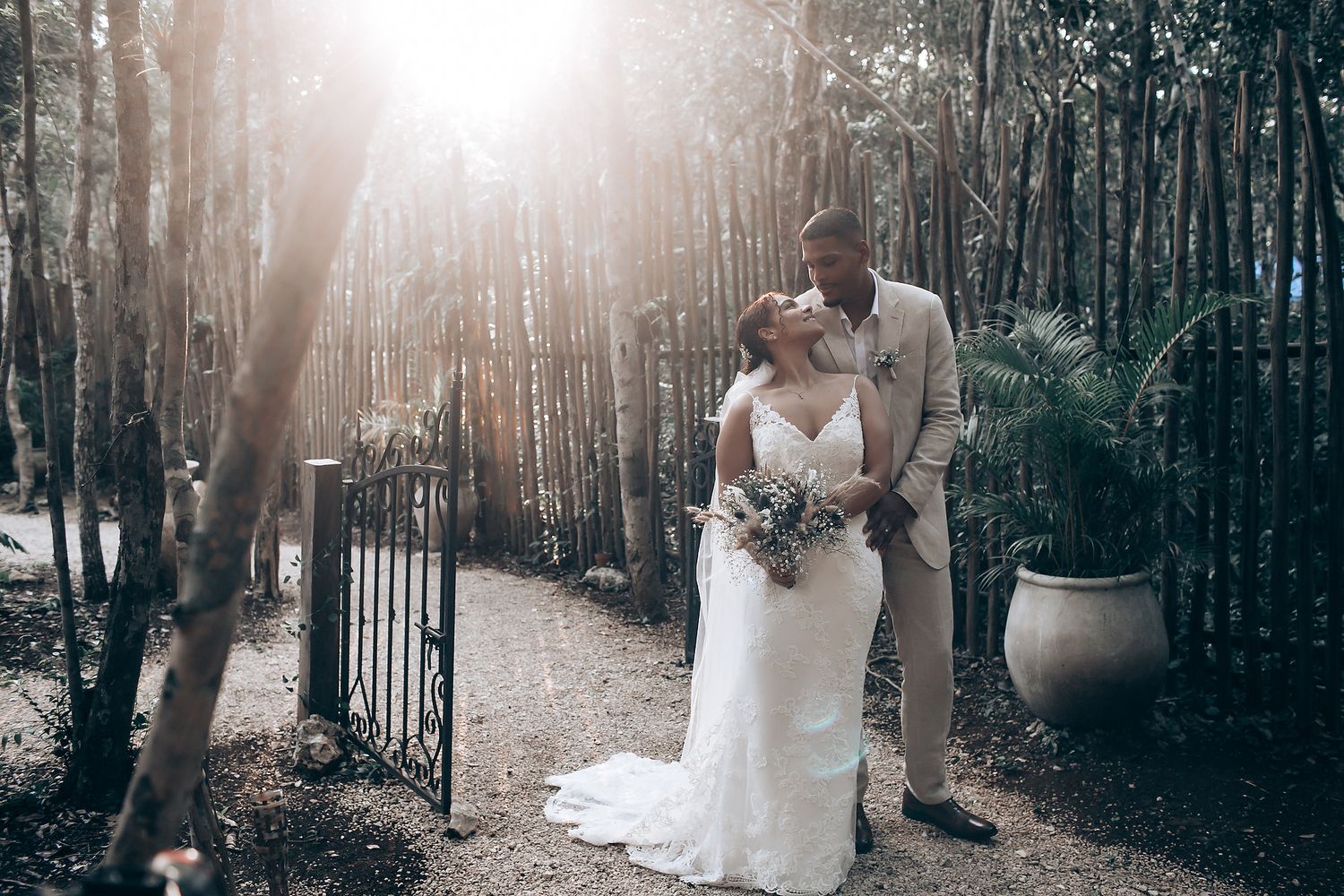 Wedding portraits captured in a misty forest setting with tall trees creating a dreamy atmosphere.