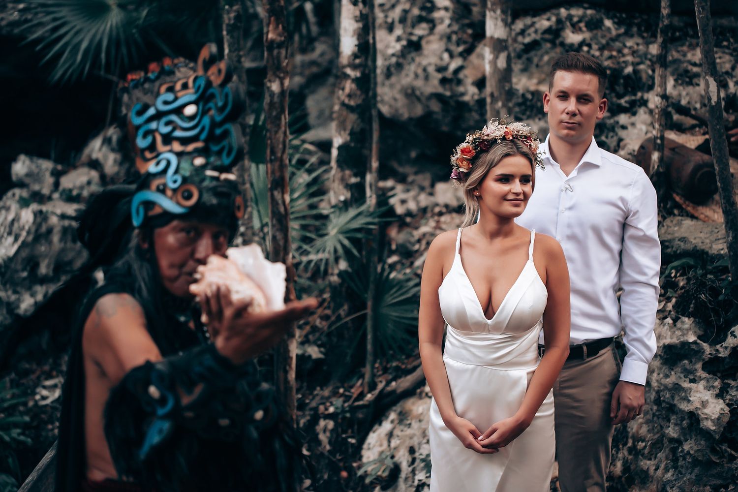 Elegant outdoor portrait session with white dress and formal attire among trees.