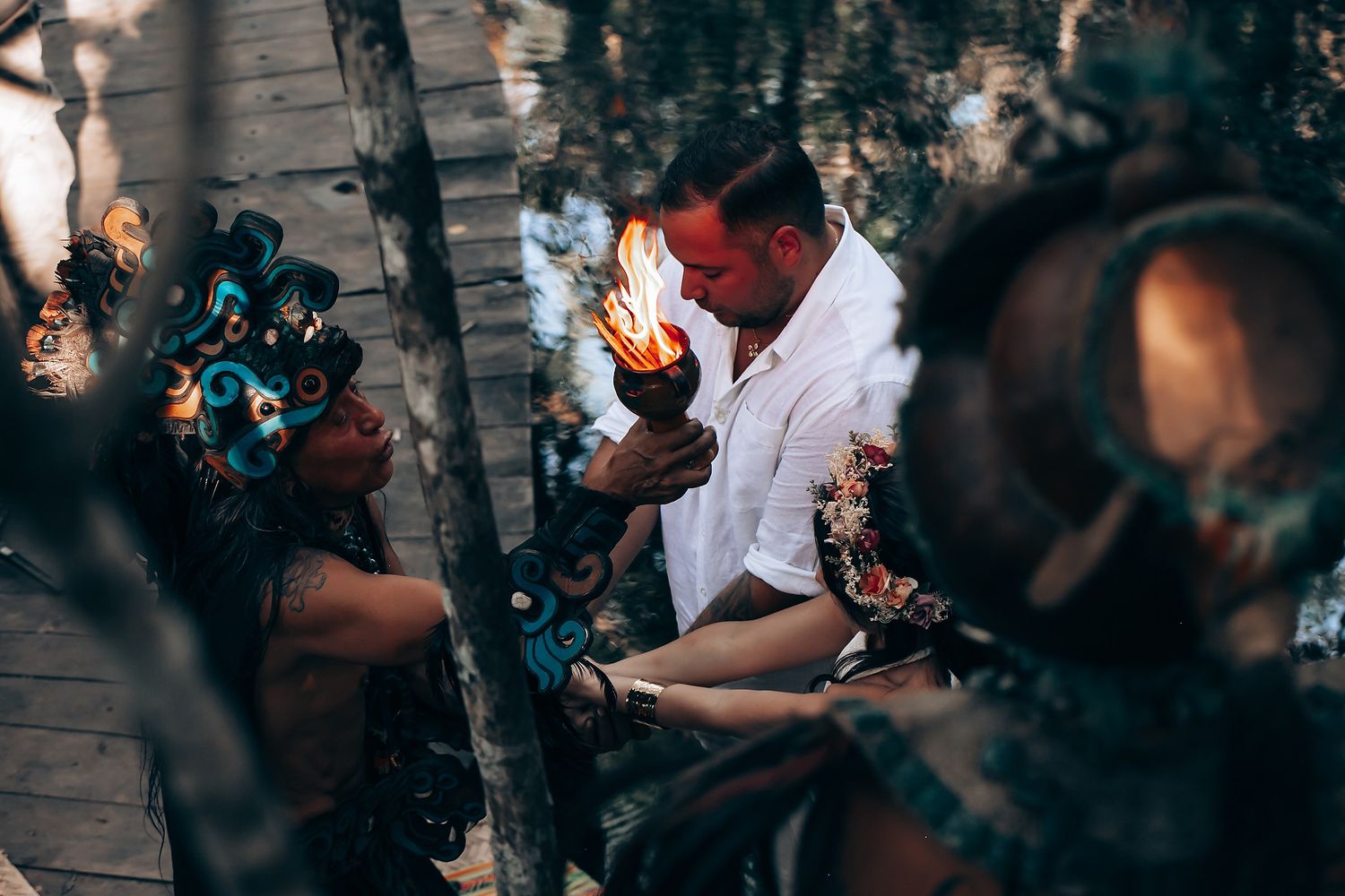 Wedding guests gathered in a wooded outdoor setting for a ceremony.