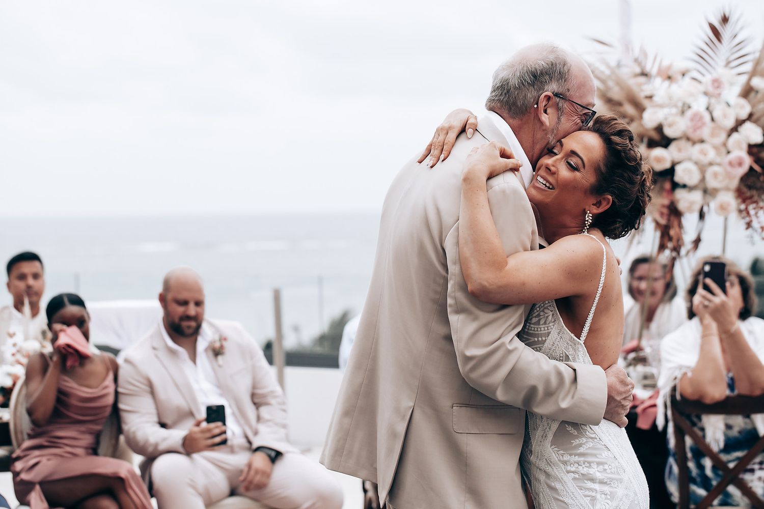 Romantic beach wedding ceremony moment with tropical decor and ocean views.