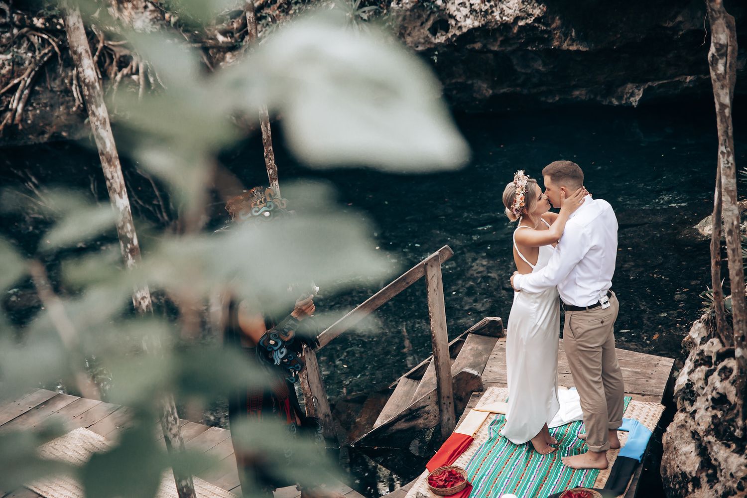 A tender embrace between newlyweds in a wooded outdoor setting.