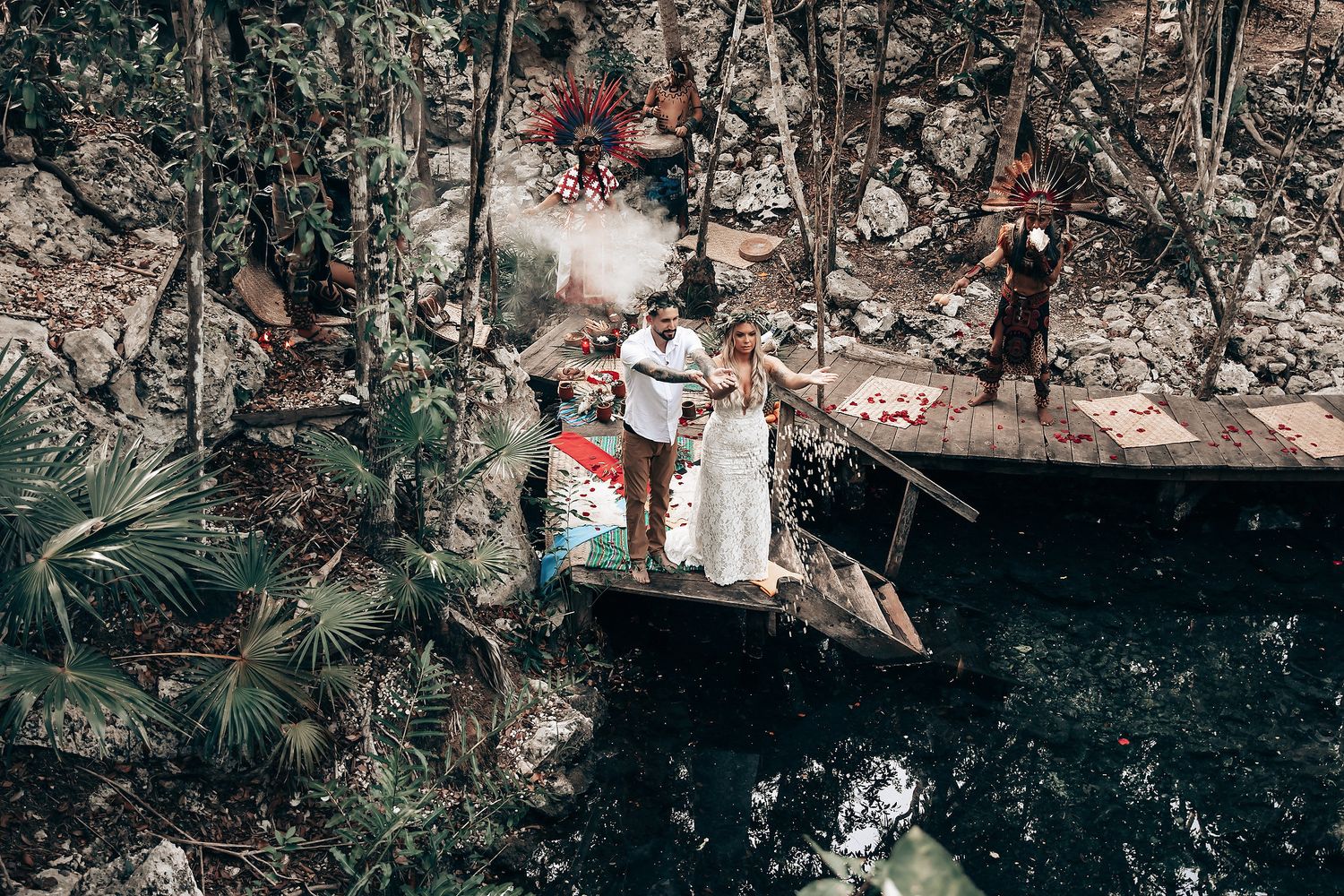 Natural forest setting with wooden platforms and greenery for an outdoor ceremony.