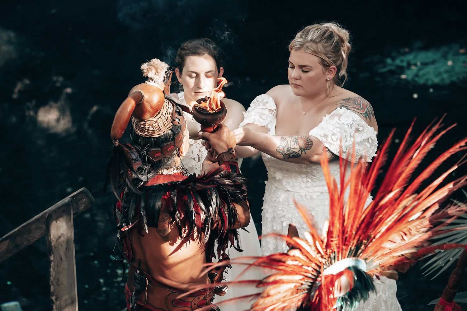 Two women in colorful traditional costumes performing a dance in an outdoor setting.