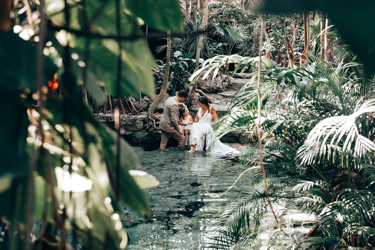 A tropical garden wedding venue decorated with natural foliage and palm trees.
