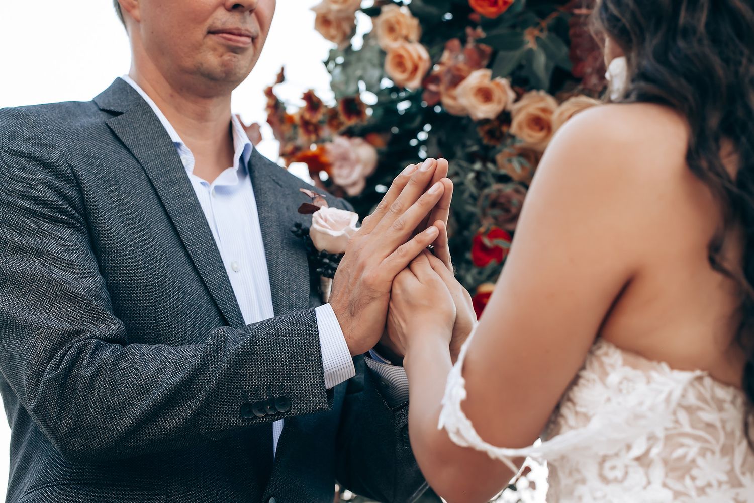 A couple shares their first dance at an elegant wedding reception surrounded by guests.
